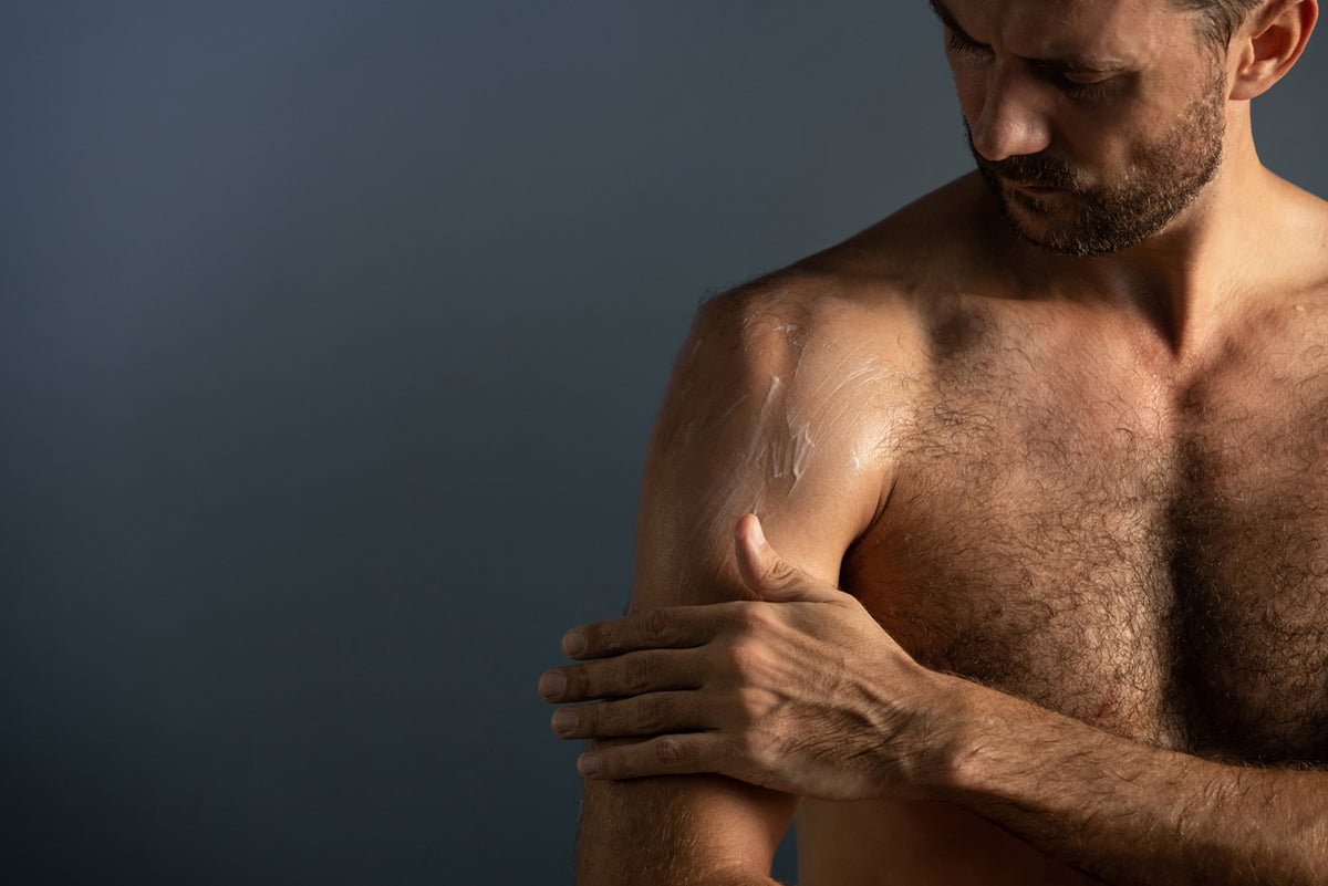 Image of male applying LEITIN Skincare body lotion