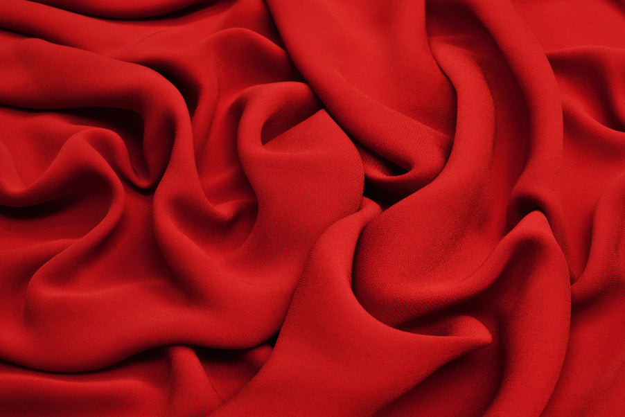 Image of red cashmere to represent soft and luxurious cream textures